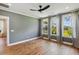Inviting bedroom with hardwood floors, a ceiling fan, and large windows for ample natural light at 3806 Grateful Rd, North Charleston, SC 29420