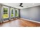 Spacious bedroom with hardwood floors, a modern ceiling fan, and bright, large windows at 3806 Grateful Rd, North Charleston, SC 29420
