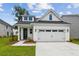 Charming new construction home featuring a two-car garage and a well-manicured lawn at 3806 Grateful Rd, North Charleston, SC 29420