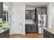 Modern kitchen with stainless steel appliances, gray cabinets, and a doorway to an outdoor view at 3806 Grateful Rd, North Charleston, SC 29420