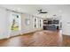 Bright living room features hardwood floors, and an open view of the modern gray kitchen at 3806 Grateful Rd, North Charleston, SC 29420