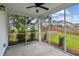 A screened in porch overlooking a green lawn with landscaping and neighboring homes at 3806 Grateful Rd, North Charleston, SC 29420