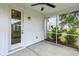 A screened in porch with a ceiling fan and an exterior door looking out to neighboring homes at 3806 Grateful Rd, North Charleston, SC 29420