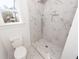 Bathroom features a rainfall shower head, white marble tiling and a built in shelf at 405 Simmons Ave, Summerville, SC 29483