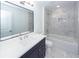 Bright bathroom featuring marble tile, a soaking tub, and a modern vanity at 405 Simmons Ave, Summerville, SC 29483