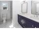 This bathroom boasts double sinks, a vanity and marble flooring at 405 Simmons Ave, Summerville, SC 29483