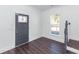 Bright entryway featuring dark wood floors, staircase and a stylish gray door at 405 Simmons Ave, Summerville, SC 29483