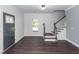 Bright entryway featuring dark wood floors, staircase and a stylish gray door at 405 Simmons Ave, Summerville, SC 29483