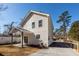 Rear exterior view of a two-story home with a covered patio and gravel driveway at 405 Simmons Ave, Summerville, SC 29483