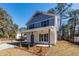 Inviting home featuring a classic facade, front porch, and a well-maintained lawn at 405 Simmons Ave, Summerville, SC 29483
