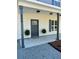 Welcoming front porch with decorative ferns and stylish porch columns at 405 Simmons Ave, Summerville, SC 29483