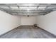 Spacious one-car garage interior with new garage door hardware and bare concrete floor at 405 Simmons Ave, Summerville, SC 29483