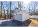 White siding garage with black hardware and gravel driveway on a sunny day at 405 Simmons Ave, Summerville, SC 29483