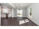 Inviting living area adjacent to kitchen, featuring hardwood floors, recessed lighting and rear entrance at 405 Simmons Ave, Summerville, SC 29483