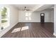 Sunlit living room with hardwood floors, ample windows and stylish front door at 405 Simmons Ave, Summerville, SC 29483