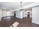 Open floor plan with hardwood floors and modern lighting connecting the living room and kitchen at 405 Simmons Ave, Summerville, SC 29483