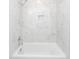 A soaking tub with shower head with marble tiling from floor to ceiling at 405 Simmons Ave, Summerville, SC 29483