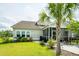 Enjoy this home's screened porch and backyard with mature landscaping, a patio, and a lush lawn at 415 True North Trail, Summerville, SC 29486