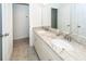 Elegant bathroom featuring double sinks, a granite countertop, and a well-lit vanity with white cabinets at 415 True North Trail, Summerville, SC 29486