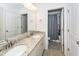 Bathroom featuring double sinks with granite countertops, vanity, and tile flooring leading into the toilet and shower area at 415 True North Trail, Summerville, SC 29486