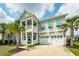 Charming two-story home with double porches, two-car garage, and tropical landscaping at 415 True North Trail, Summerville, SC 29486