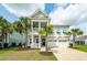 Charming home with a two-story porch, well-manicured lawn, and beautiful palm trees at 415 True North Trail, Summerville, SC 29486