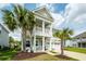 Beautiful two-story home with a double porch, lush landscaping, and a two car garage at 415 True North Trail, Summerville, SC 29486