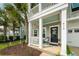 Inviting front porch with white railings, and a cozy seating area at 415 True North Trail, Summerville, SC 29486