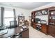 Bright home office featuring a large desk, custom cabinets, and a comfortable workspace with natural lighting at 415 True North Trail, Summerville, SC 29486