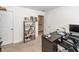 Organized home office space with a dark wood desk, comfortable chair, and shelving for books and supplies at 415 True North Trail, Summerville, SC 29486