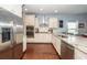 Modern kitchen with stainless steel appliances, white cabinets, and granite countertops at 415 True North Trail, Summerville, SC 29486