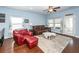 Cozy living room with bright windows, a ceiling fan, and hardwood floors at 415 True North Trail, Summerville, SC 29486