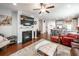 Open-concept living room featuring a fireplace, ceiling fan, and hardwood floors at 415 True North Trail, Summerville, SC 29486