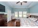 The main bedroom features a tray ceiling, hardwood floors, wainscoting, and sun-filled windows at 415 True North Trail, Summerville, SC 29486