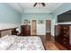 A main bedroom features hardwood floors, a tray ceiling, and access to the ensuite bath and closet at 415 True North Trail, Summerville, SC 29486