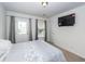 Cozy main bedroom with an exterior door, gray curtains, and a mounted television for relaxed living at 415 True North Trail, Summerville, SC 29486