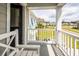A charming porch with white railings and a welcoming bench, perfect for enjoying the outdoors at 415 True North Trail, Summerville, SC 29486