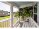 Relax on this charming porch, featuring a bench, white railings and a relaxing view at 415 True North Trail, Summerville, SC 29486