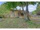 Backyard with an elevated deck, mature trees, a screened in porch, and an air conditioning unit at 4606 Moss Ct, North Charleston, SC 29420