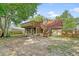 The exterior features a tiered wooden deck, a screened porch, and a spacious backyard with lush greenery at 4606 Moss Ct, North Charleston, SC 29420