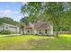 Charming single-story home with a well-maintained lawn and mature trees on a sunny day at 4606 Moss Ct, North Charleston, SC 29420