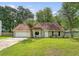 Charming single-story home with a two-car garage, manicured lawn, and mature trees at 4606 Moss Ct, North Charleston, SC 29420