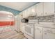 View of the kitchen with white cabinets, appliances, and tile backsplash at 4606 Moss Ct, North Charleston, SC 29420