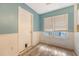 Eat-in kitchen area featuring white wainscoting and a large window at 4606 Moss Ct, North Charleston, SC 29420