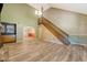 Bright living room with hardwood floors, a wooden staircase, and a high ceiling providing a spacious feel at 4606 Moss Ct, North Charleston, SC 29420