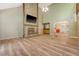 Bright living room with a stone fireplace, wet bar, wood floors, and open layout perfect for entertaining at 4606 Moss Ct, North Charleston, SC 29420