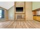 Spacious living room with a floor-to-ceiling stone fireplace, wood-look floors, wet bar, and vaulted ceilings at 4606 Moss Ct, North Charleston, SC 29420