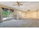 Carpeted bonus room features a ceiling fan, a sliding glass door to a deck, and natural light at 4606 Moss Ct, North Charleston, SC 29420