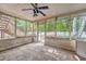 Enclosed porch offers an outdoor space with a ceiling fan, screened walls, and wooden steps to the backyard at 4606 Moss Ct, North Charleston, SC 29420