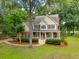 Beautiful home with mature trees on a spacious lot with lush landscaping at 5195 Forest Oaks Dr, Hollywood, SC 29449